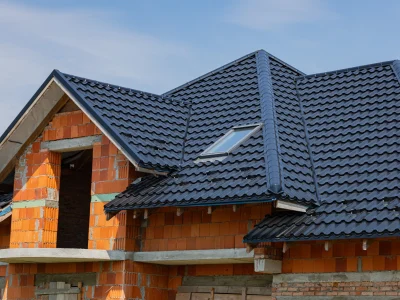 vecteezy_a-metallic-tiled-roof-is-being-installed-on-a-residential_68030158